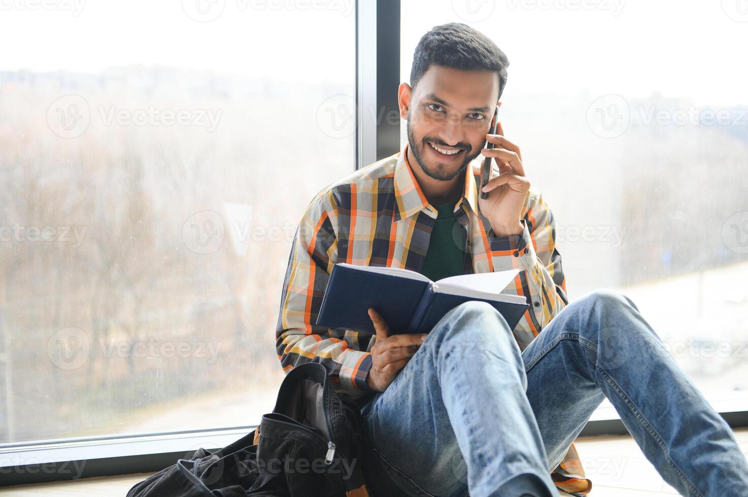 Happy indian male student at the university photo
