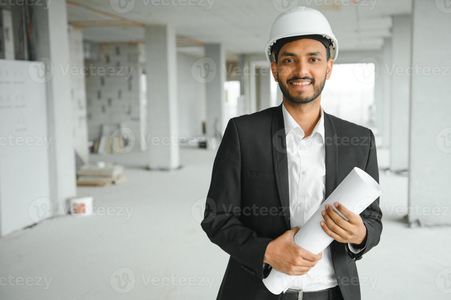 Asian engineer handsome man or architect with white safety helmet in construction site. Standing at modern building construction. Worker asian man working project building photo