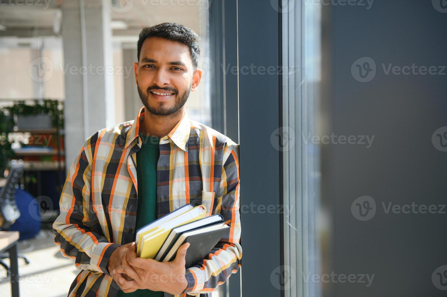 indian student with books at university photo