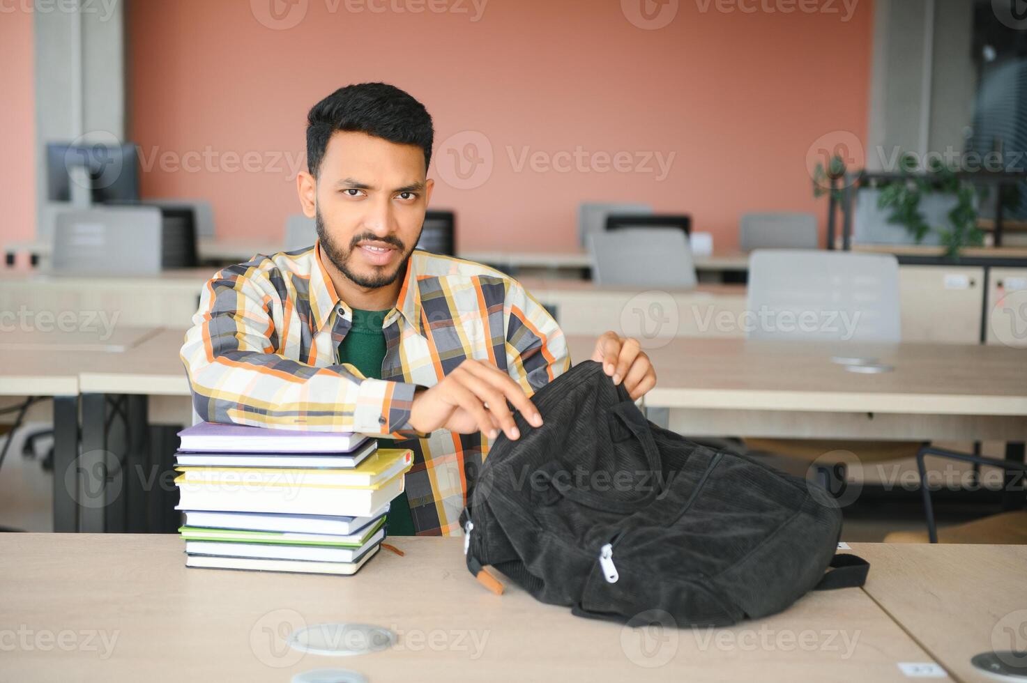 Happy indian male student at the university photo