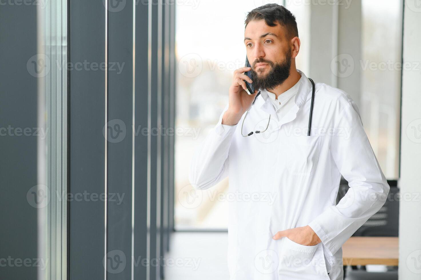 Portrait of a young arabian doctor standing in the the clinic photo