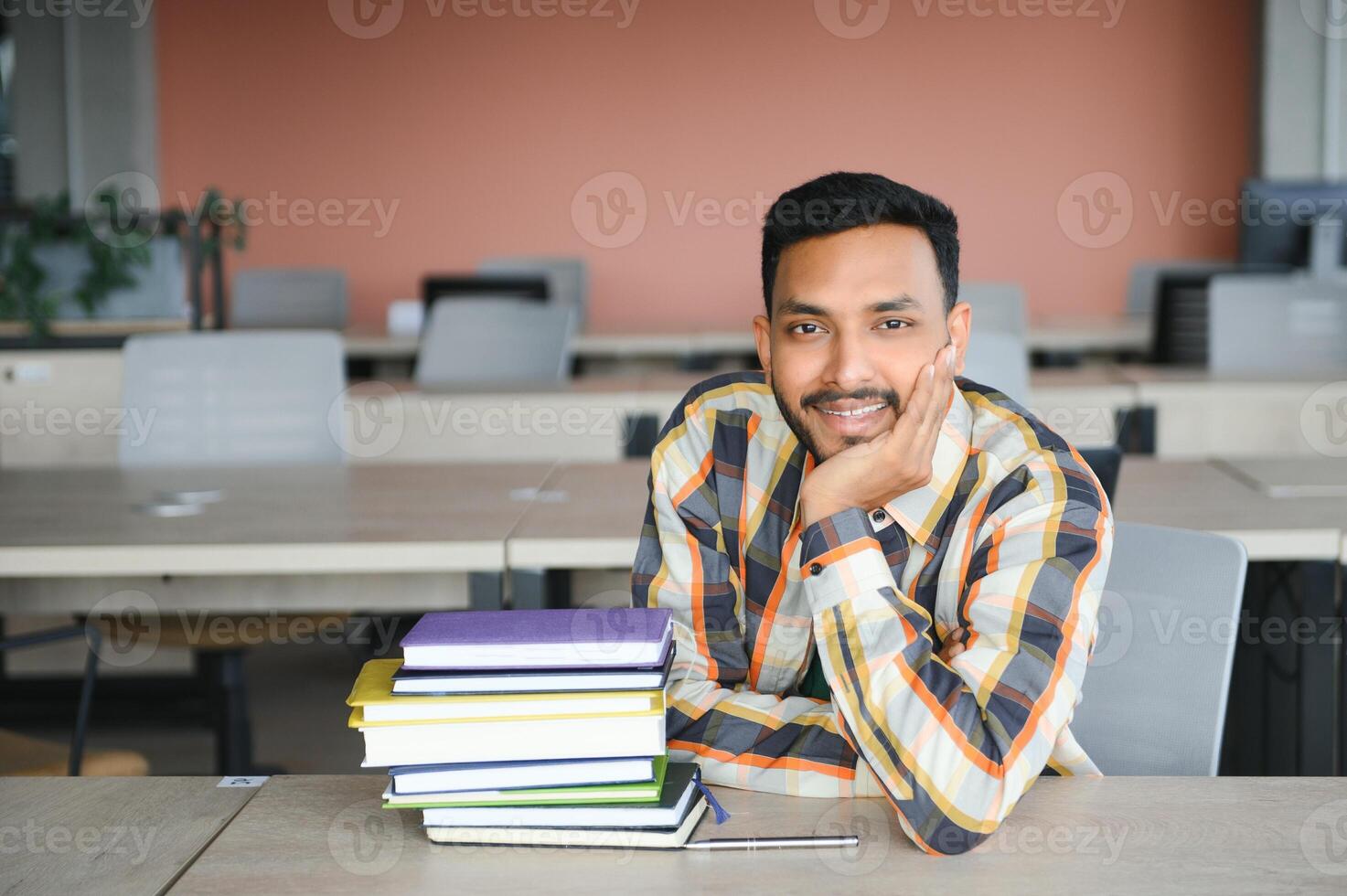 Happy indian male student at the university photo