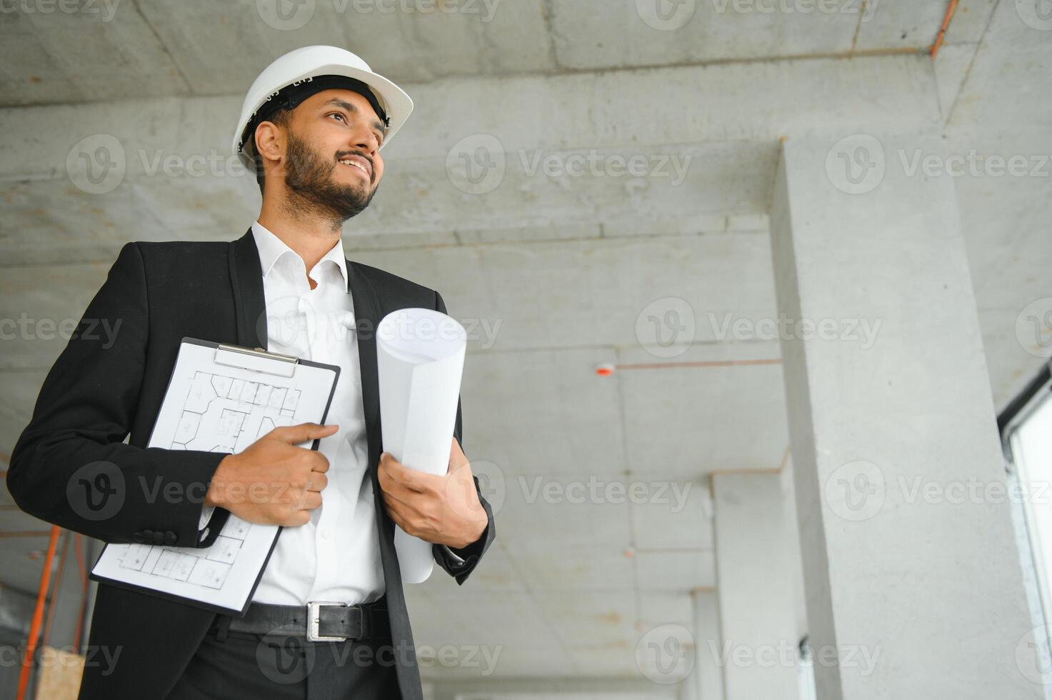 architecture, construction business and building concept - happy smiling indian male architect in helmet. photo