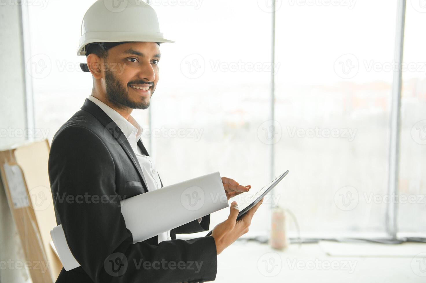 Asian engineer handsome man or architect with white safety helmet in construction site. Standing at modern building construction. Worker asian man working project building photo