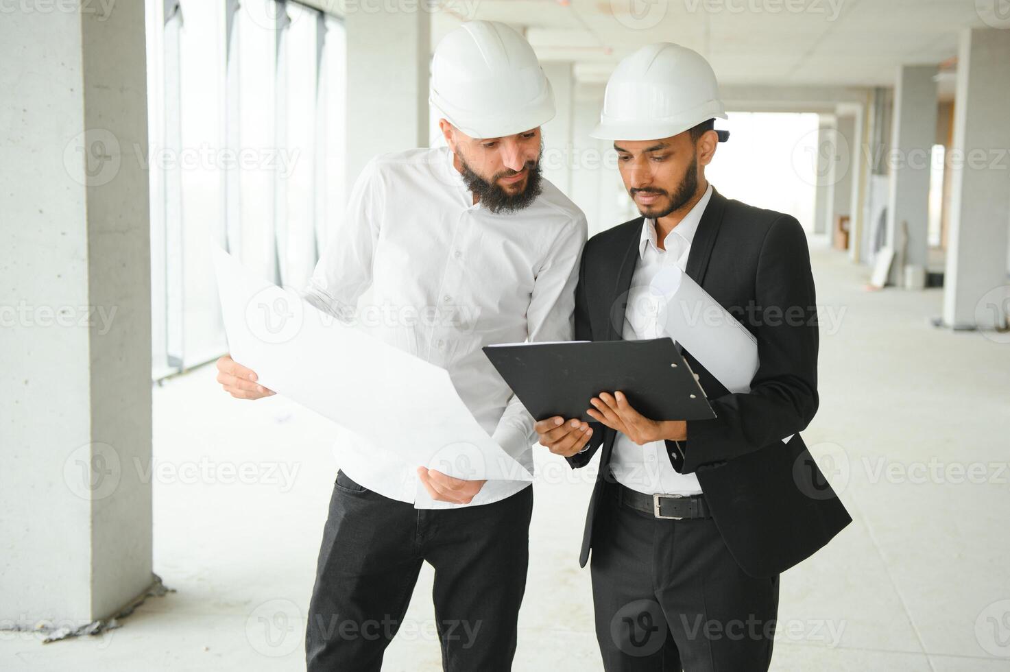Construction concept of multiracial Engineer and Architect working at Construction Site with blue print photo