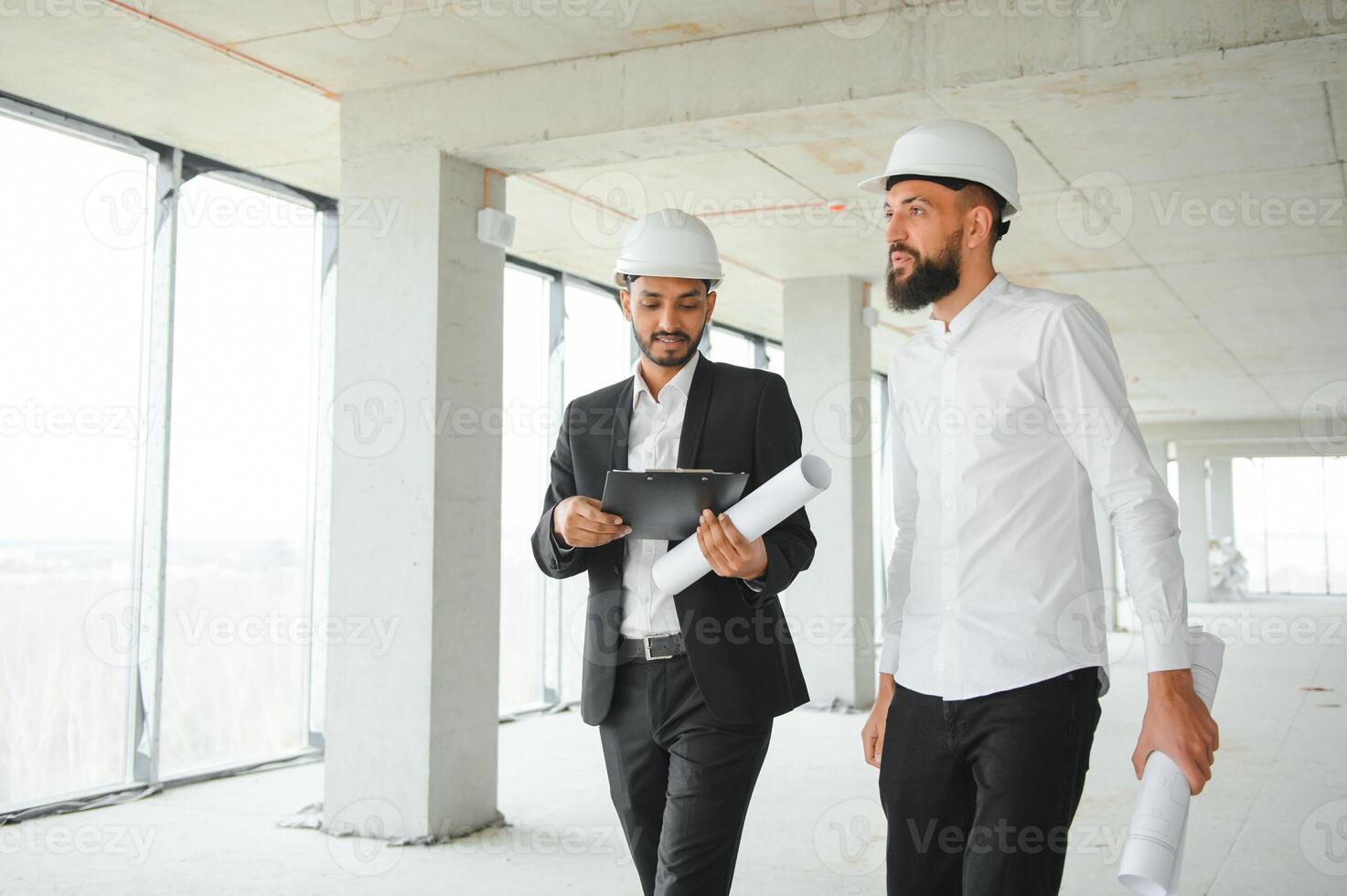 Construction concept of multiracial Engineer and Architect working at Construction Site with blue print photo