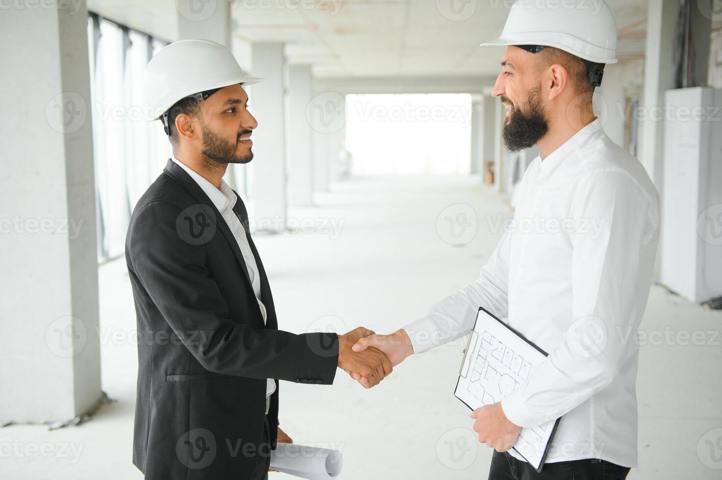 Construction concept of multiracial Engineer and Architect working at Construction Site with blue print photo