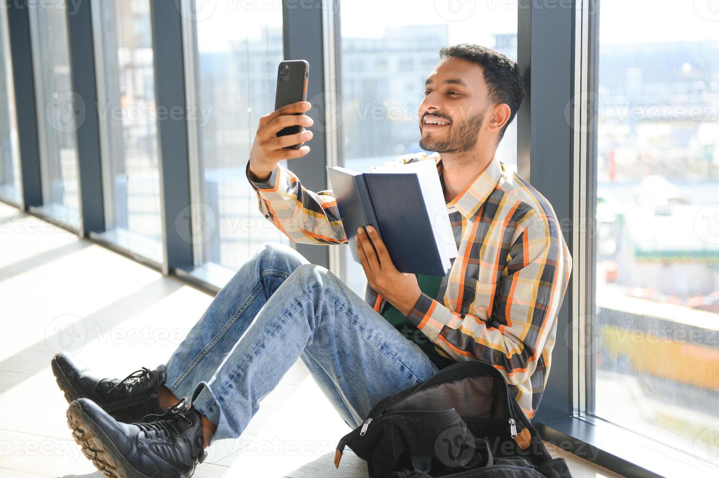 Happy indian male student at the university photo