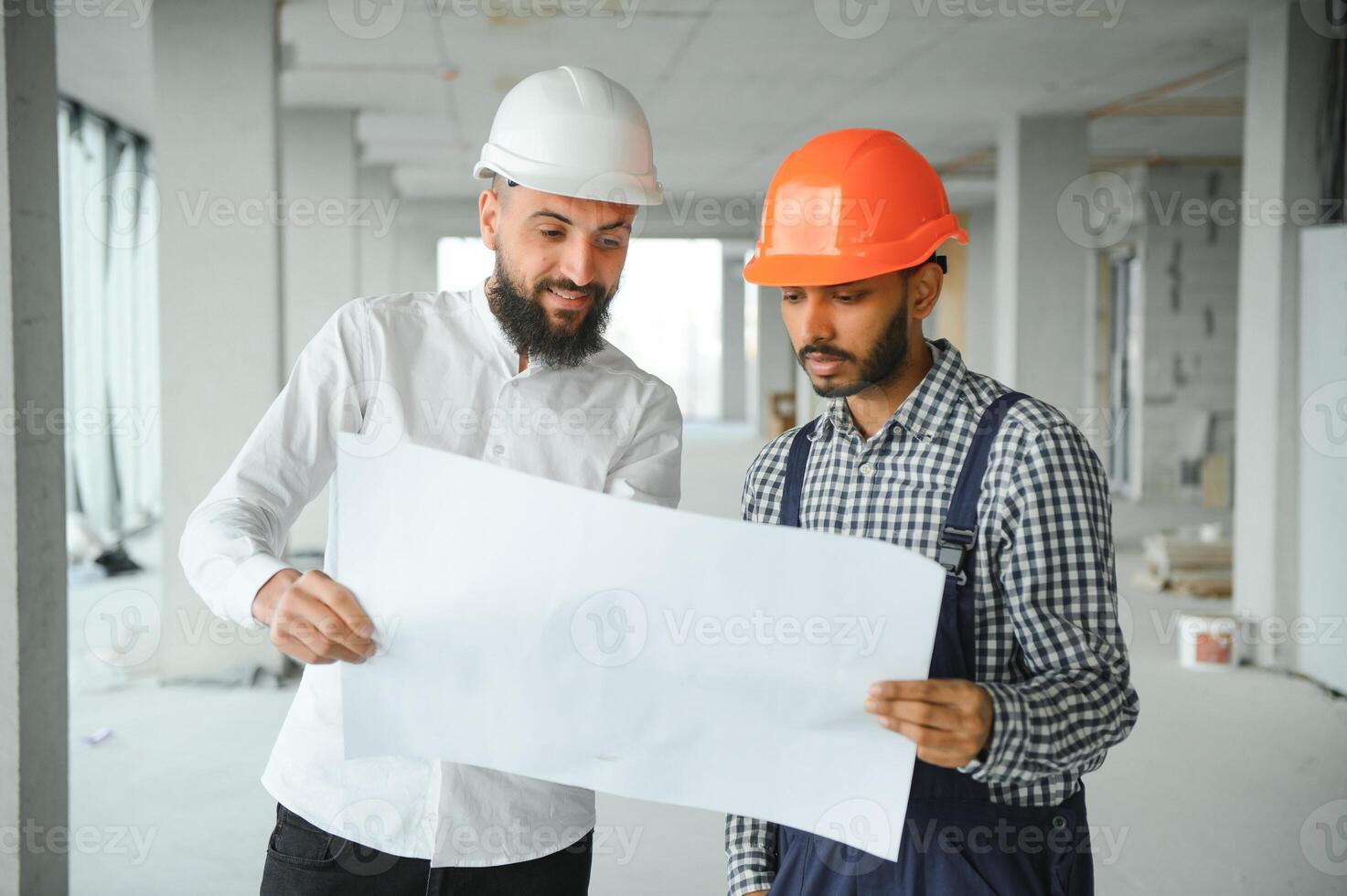 Indian and Arabian engineers. Contractor and architect talking about working on big project. Building in construction process interior. photo