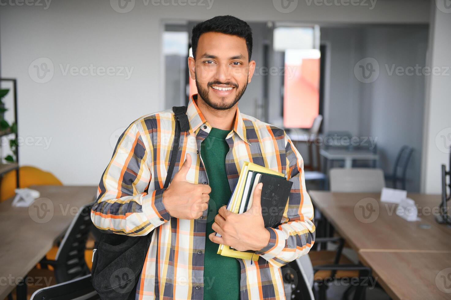 Happy indian male student at the university photo