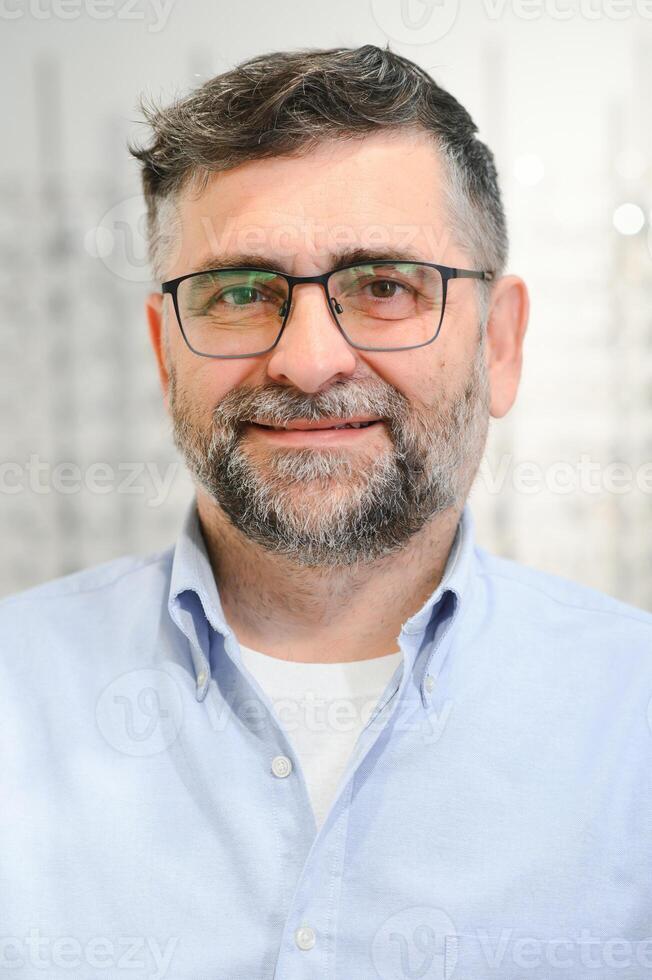 Glasses check, senior vision and elderly man at a consulting optometry clinic for wellness. Happy, smile and old face with lens, frame and eyewear choice in a store for help getting a prescription. photo