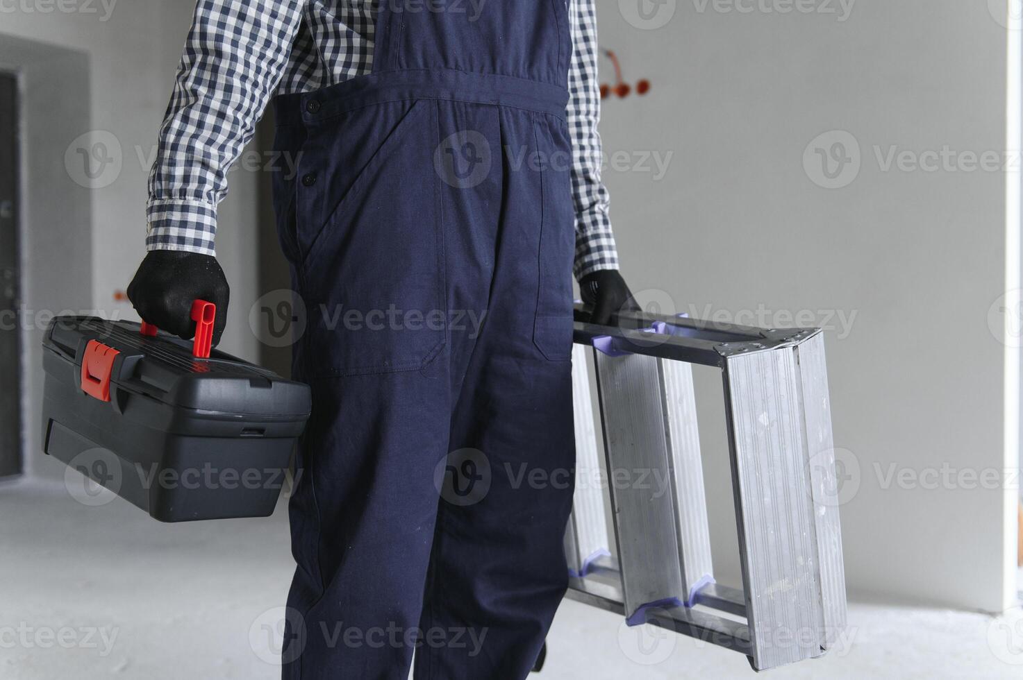 Builder handyman with construction tools. House renovation background. photo
