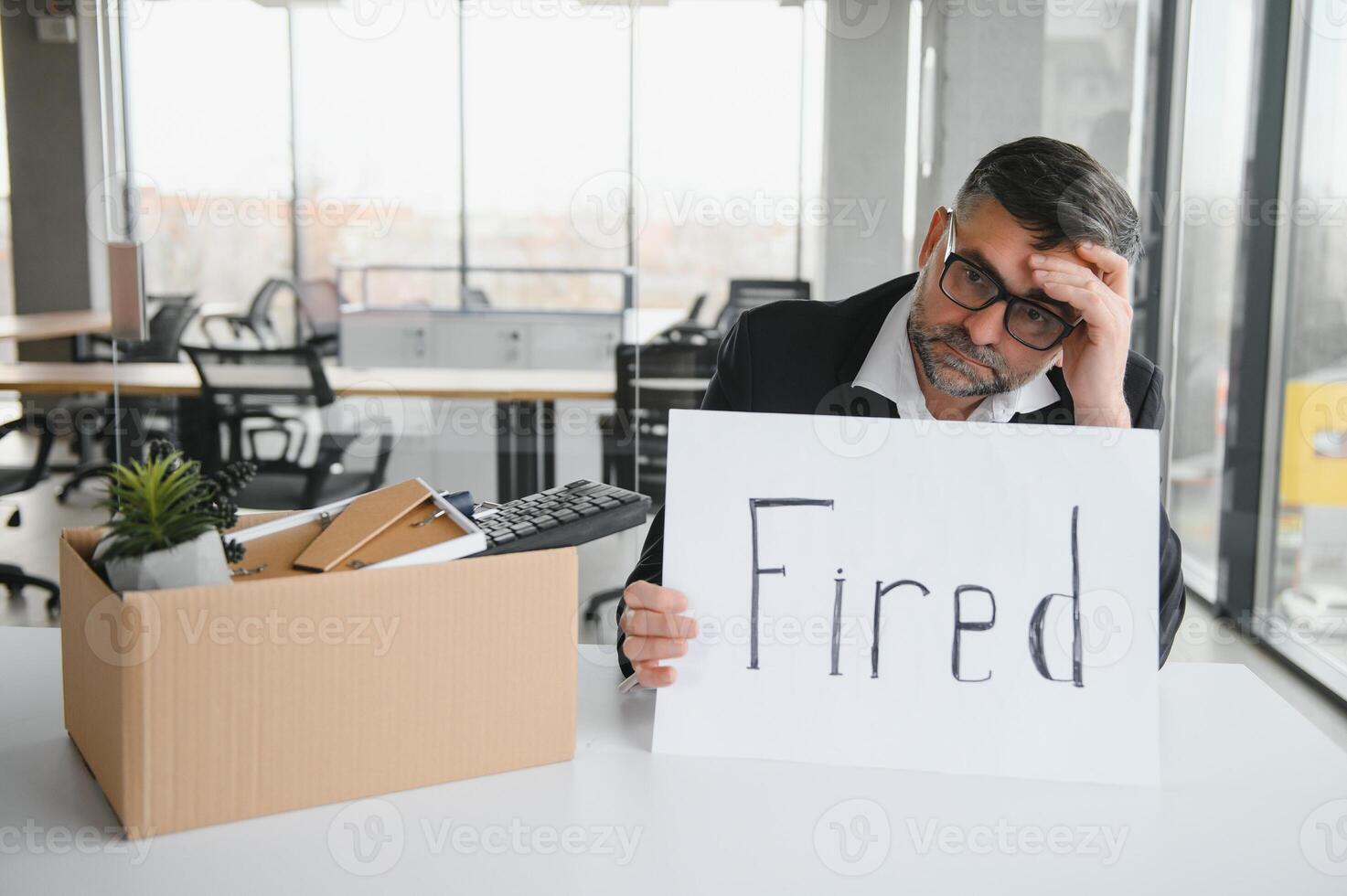 Old male employee in dismissal concept photo