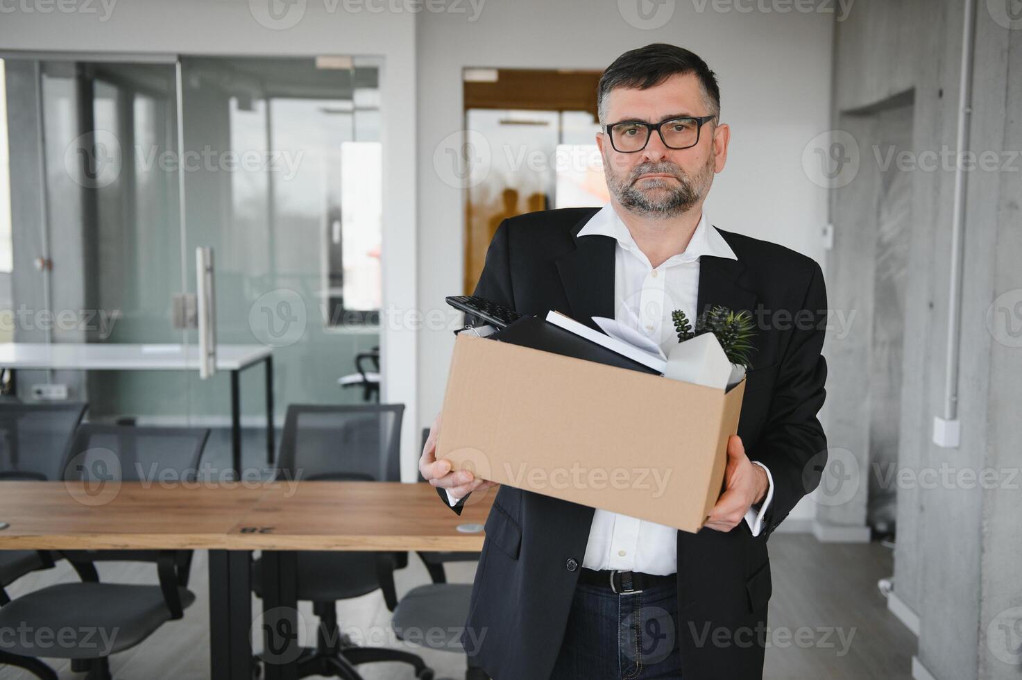 Portrait of sad dismissed senior old business man worker taking his office supplies in the box. Pensioner mature retire from work carry staff back home. Lifestyle business retirement, quit job concept photo