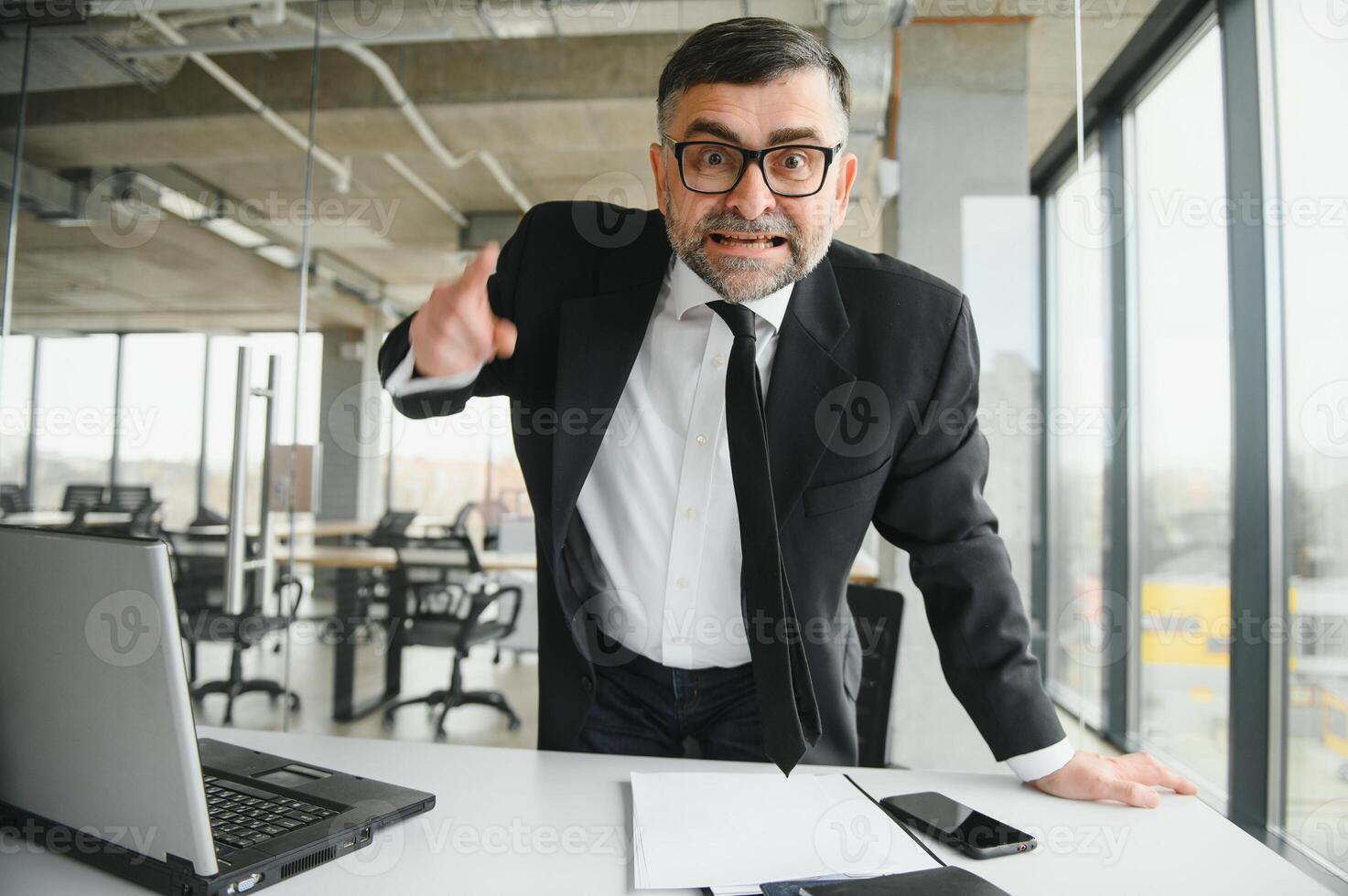 Angry boss shouting at his employee photo