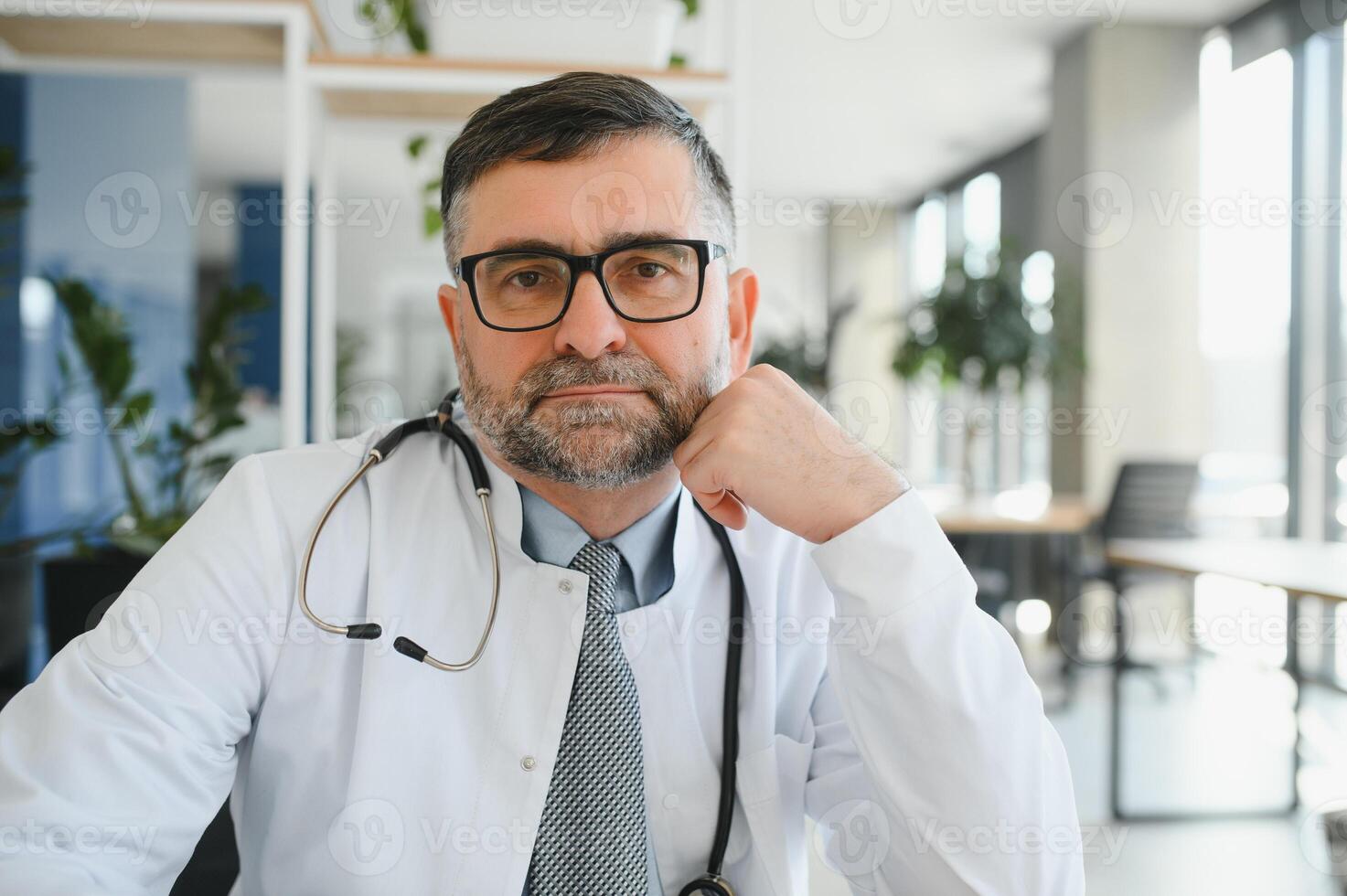 Portrait of senior doctor in white coat photo