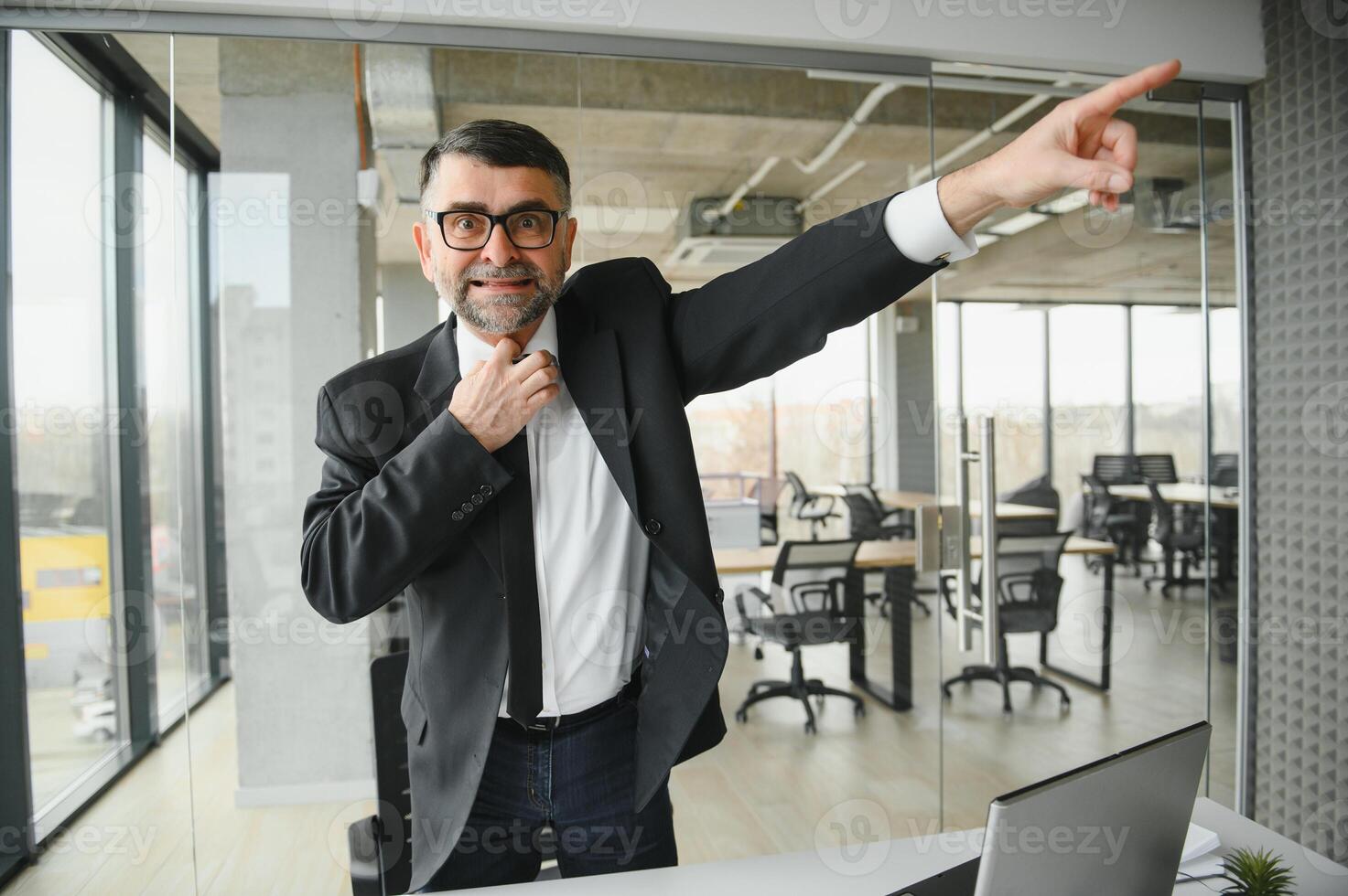 Angry boss behind of office table photo