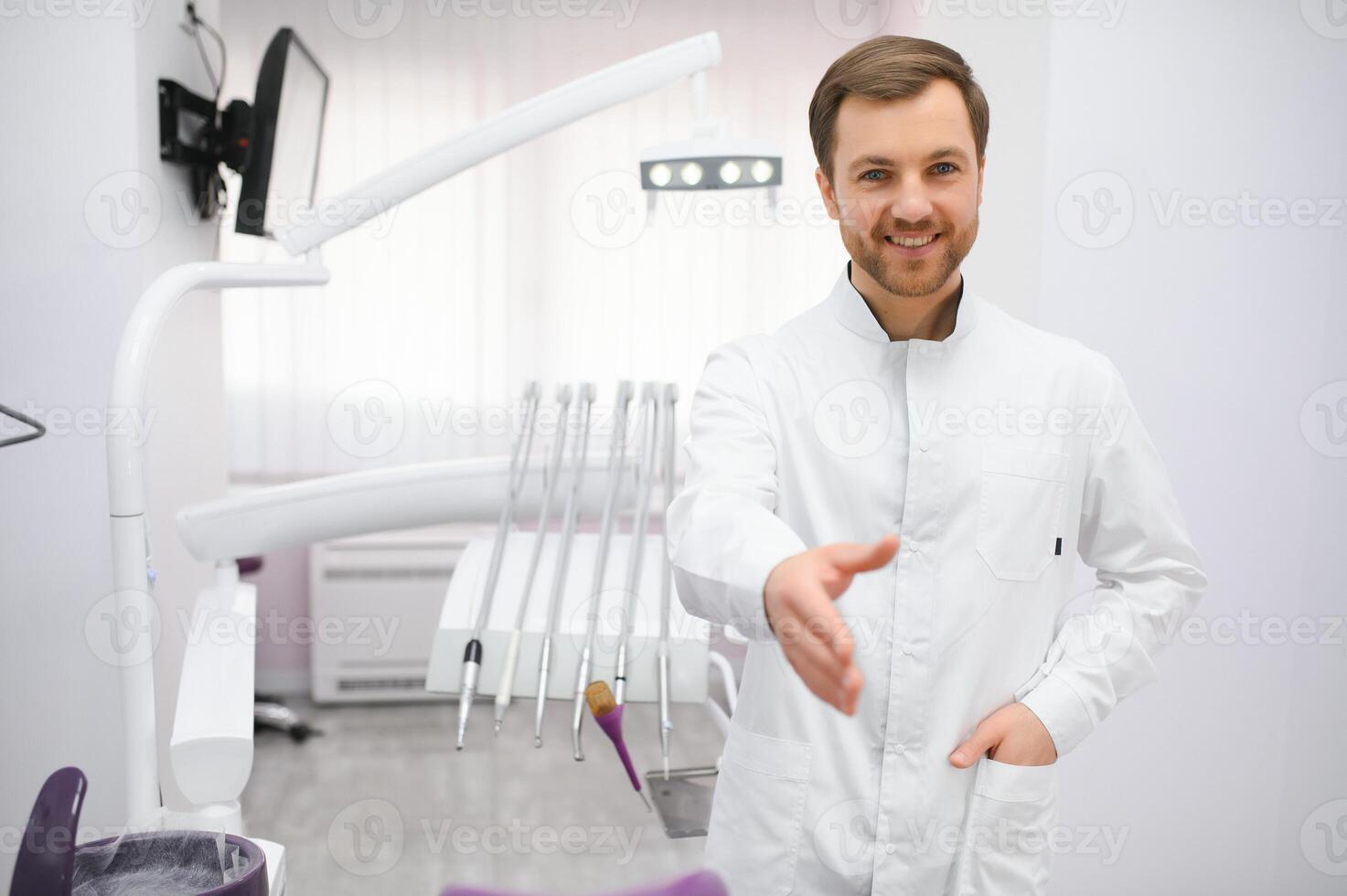 Young male dentist in clinic photo