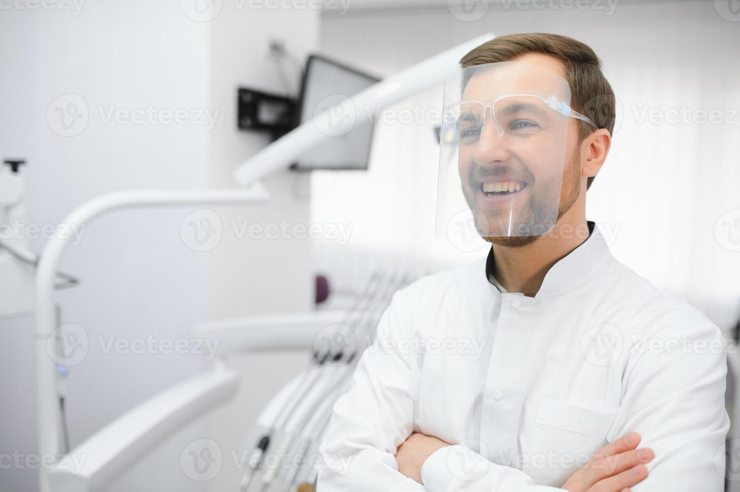 Young male dentist in clinic photo