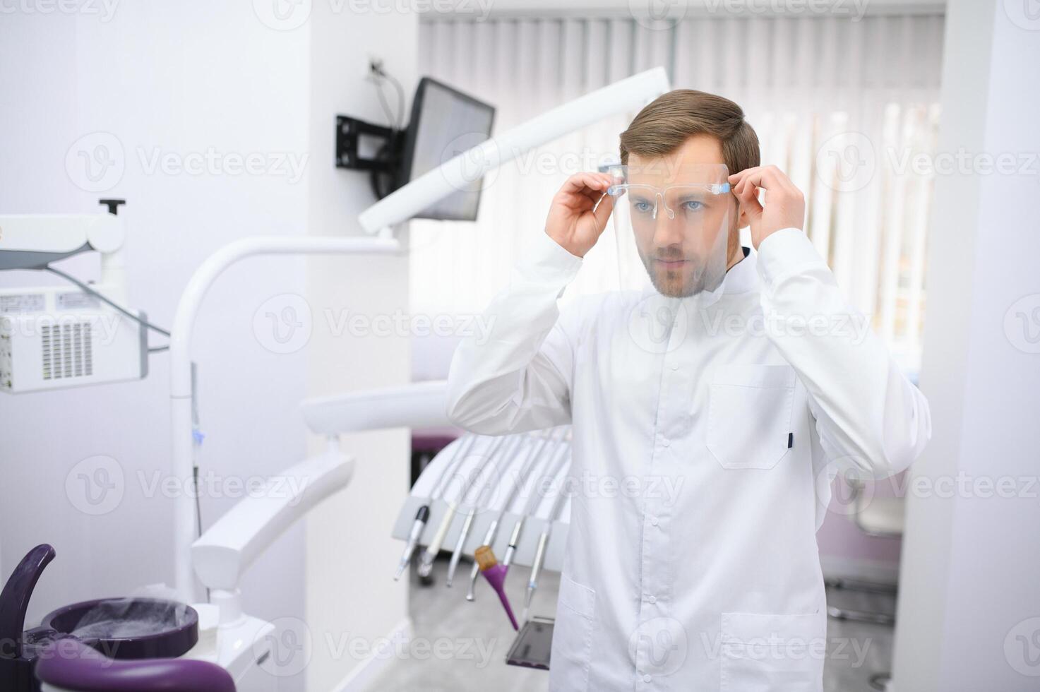 Young male dentist in clinic photo
