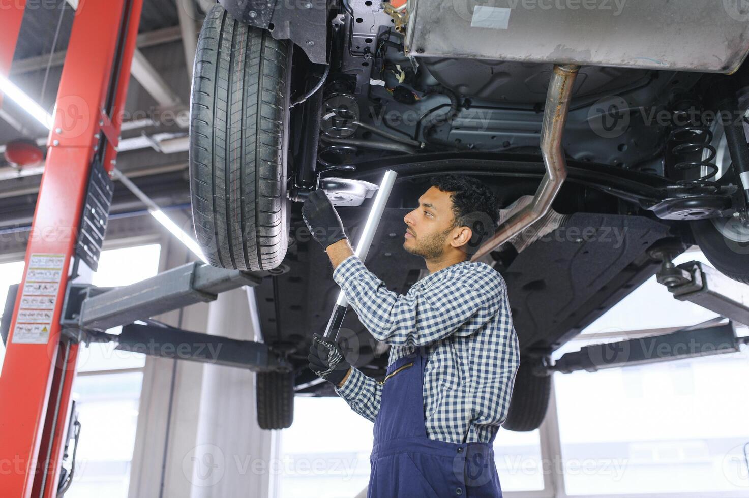 Indian happy auto mechanic in blue suit. photo