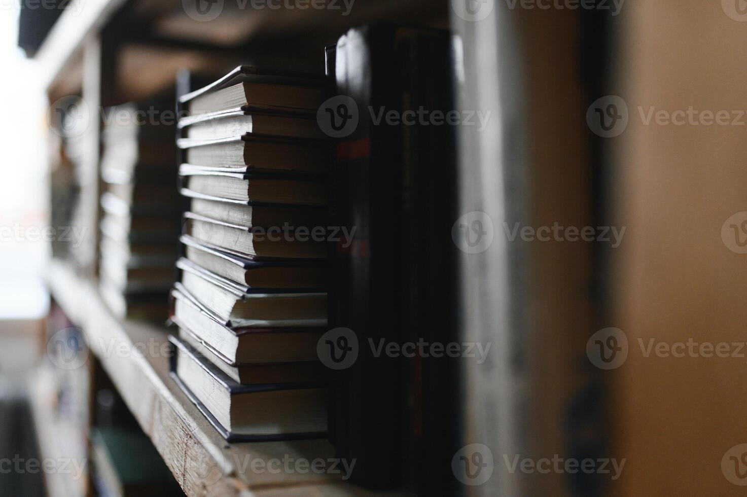 Blurred background of shelf with many multicolored books photo