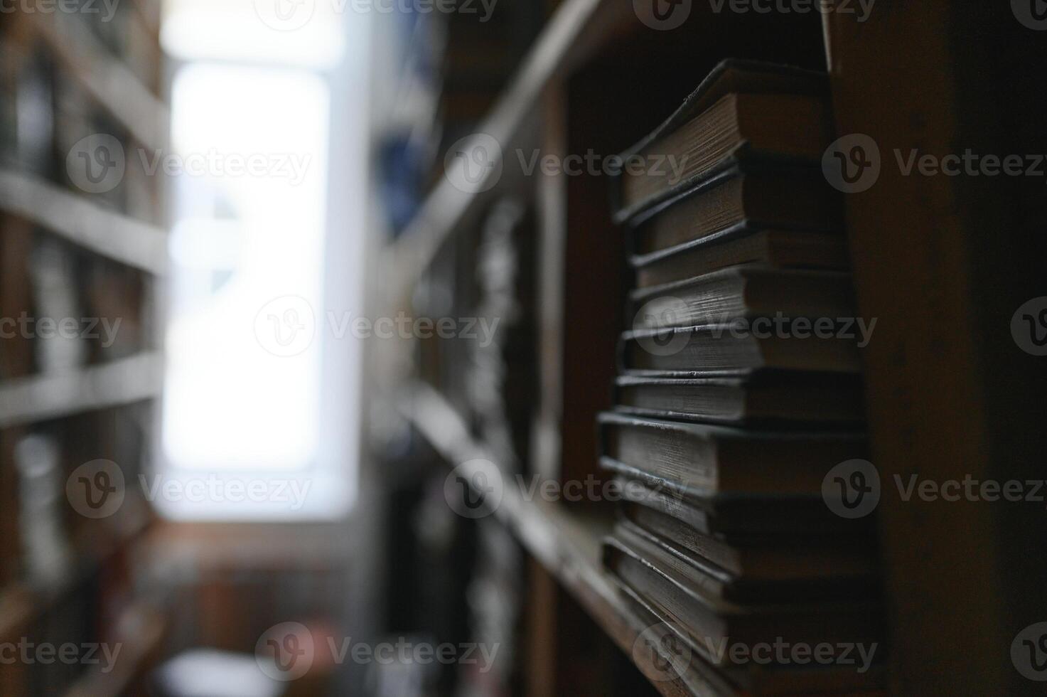 Blurred background of shelf with many multicolored books photo