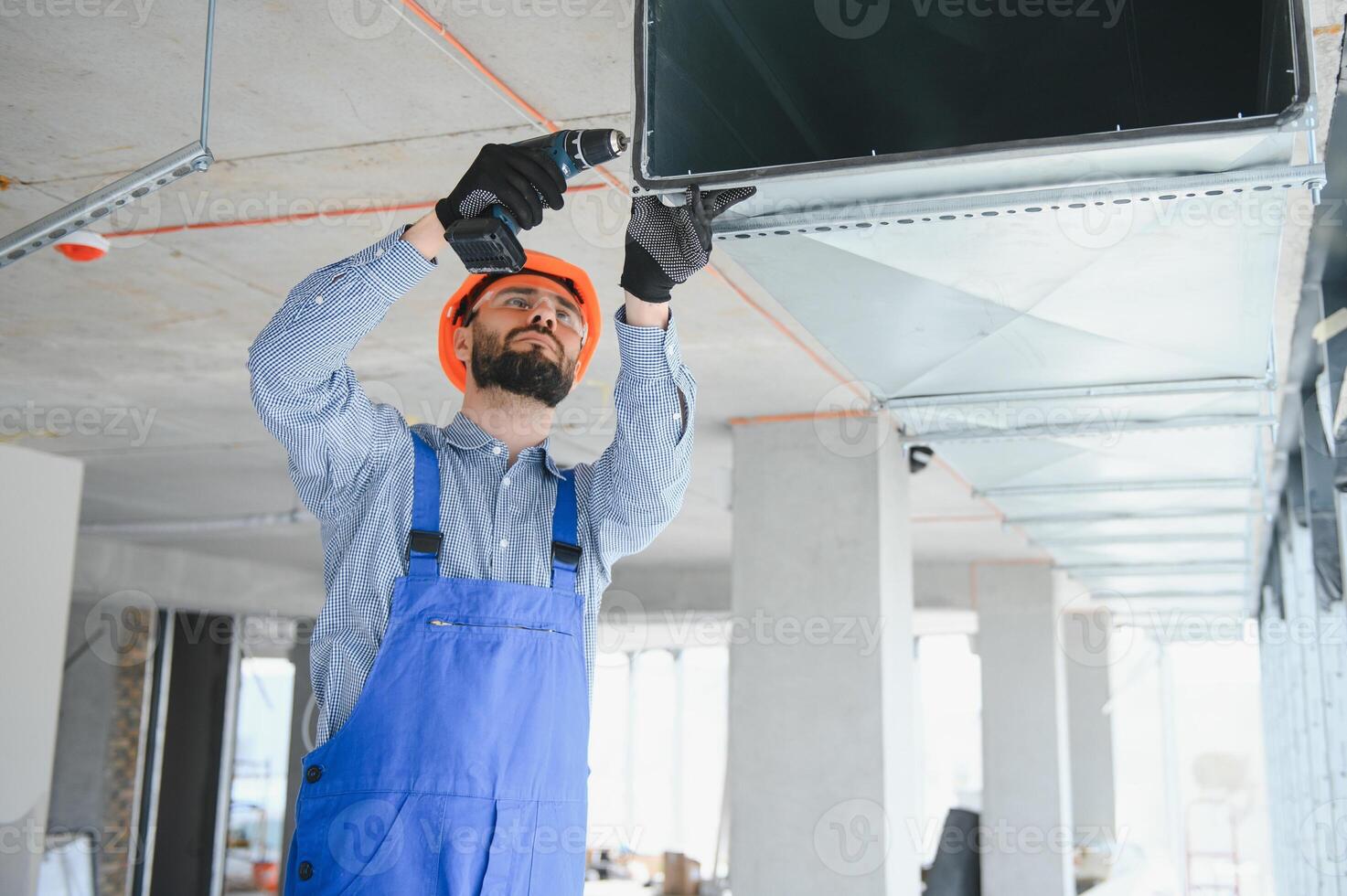 hvac engineer install heat recovery ventilation system for new house. copy space photo