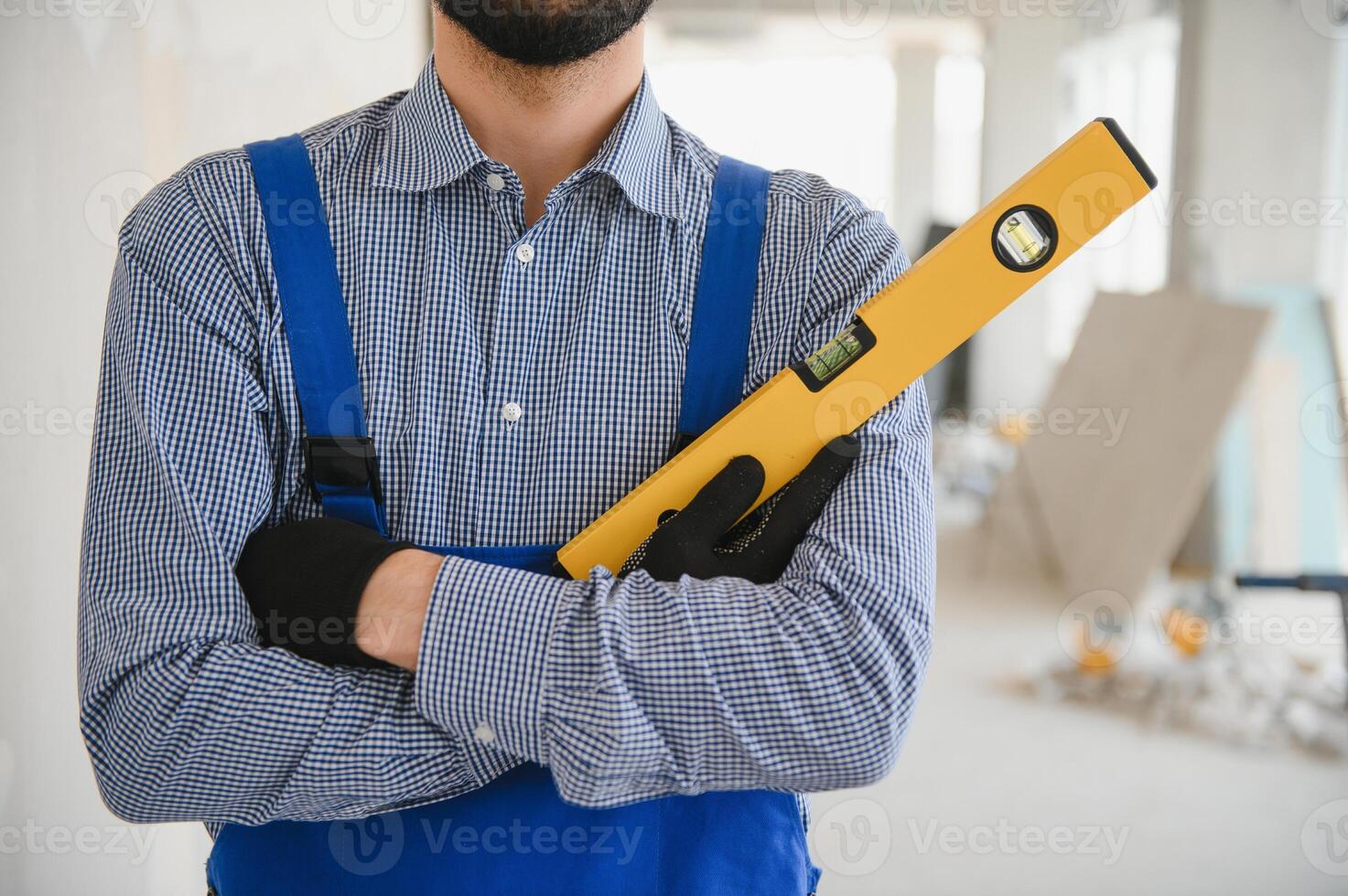 Worker checking vertical level with bubble level tool photo