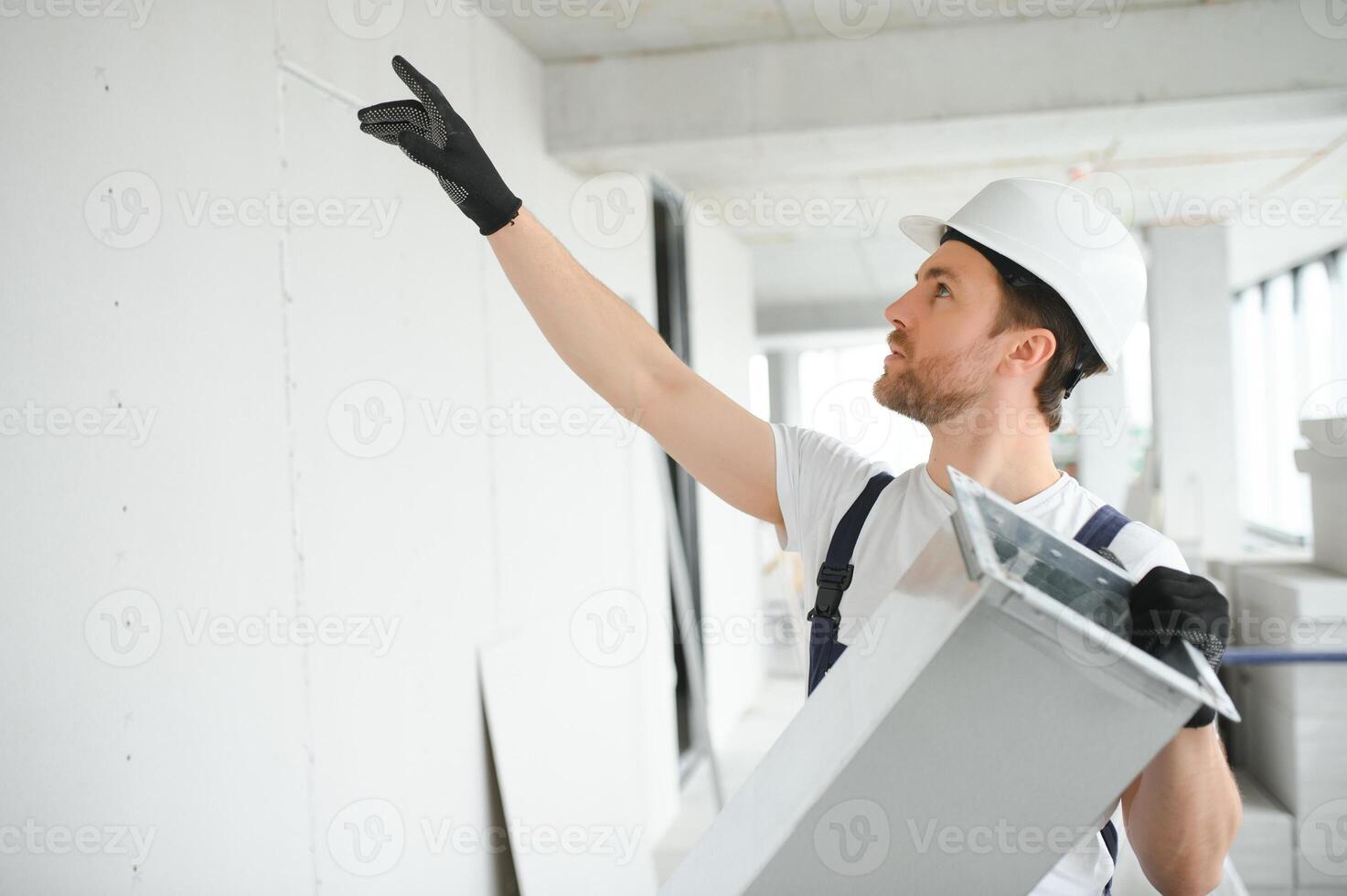 Professional HVAC Worker on a Aluminium Scaffolding Installing Air Duct Inside Newly Built Commercial Building. Industrial Theme photo