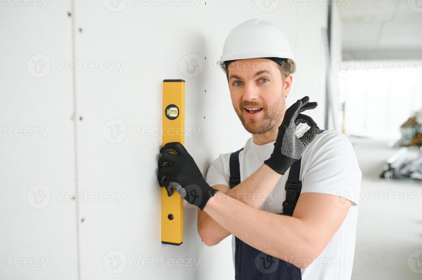 Professional Workman Applying Silicone Sealant With Caulking Gun on the Wall photo