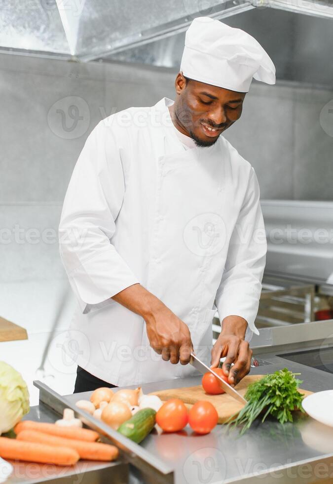 Gourmet chef in uniform cooking in a commercial kitchen. photo