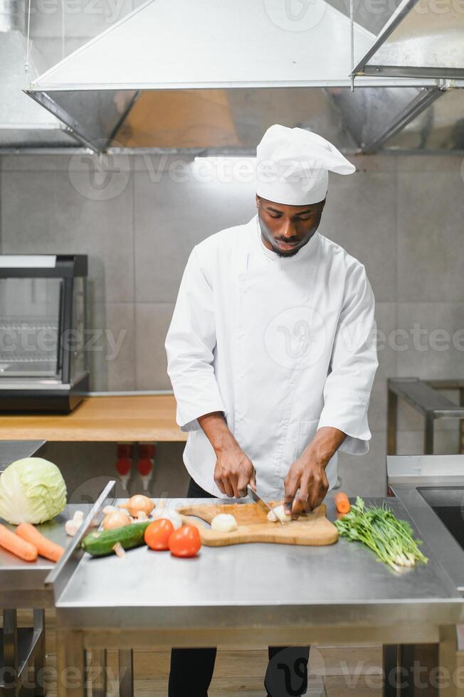 handsome african american chef at restaurant kitchen photo