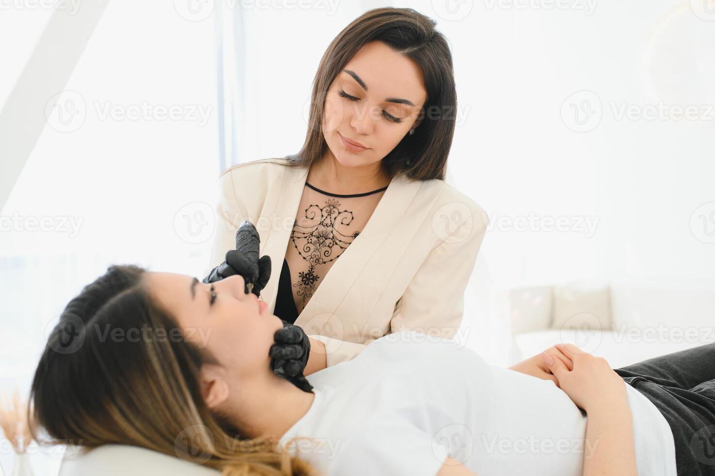 Permanent make up procedure. Lip makeup in tattoo salon. photo