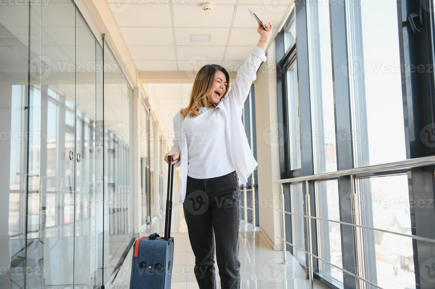 Pretty young female passenger at the airport photo