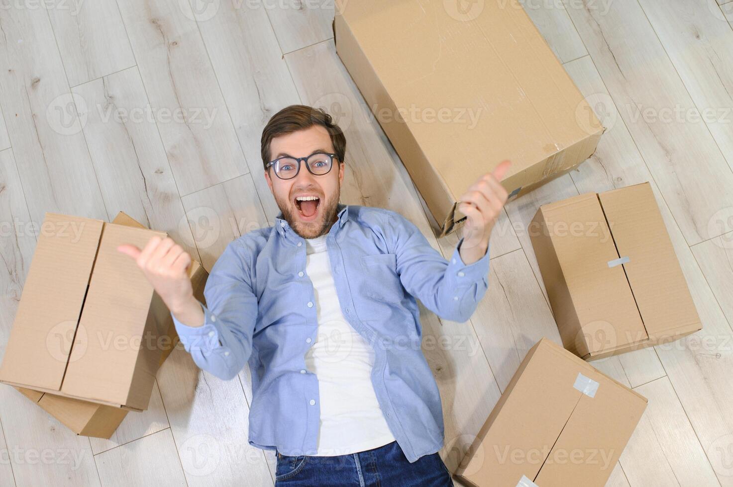 Smiling guy moving into his new home photo