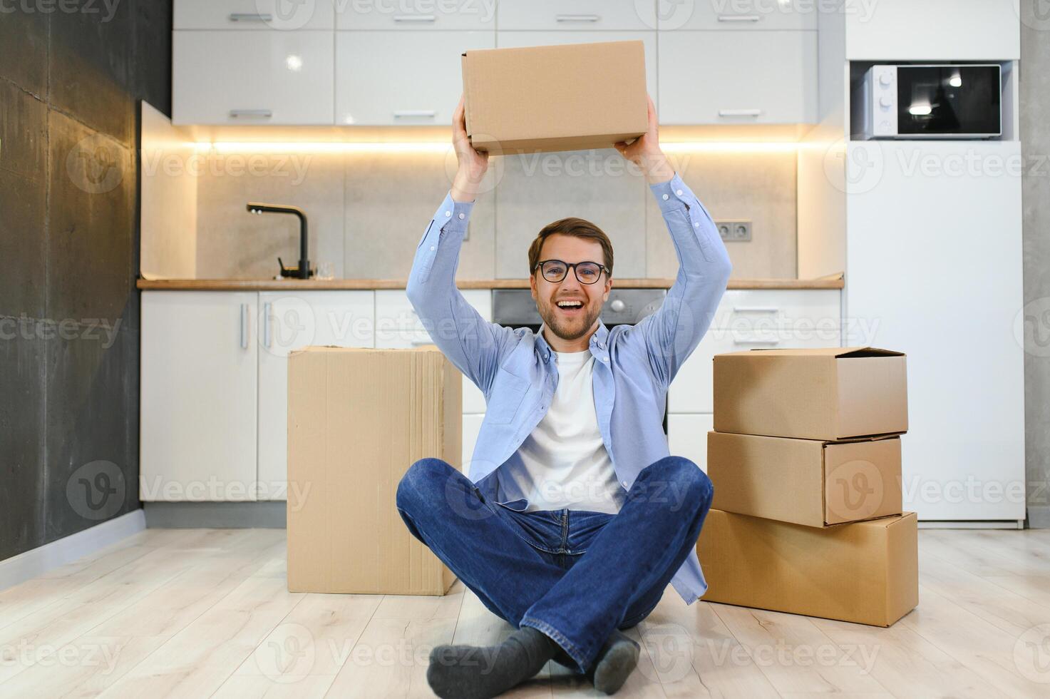 Happy man with cardboard box in new home photo