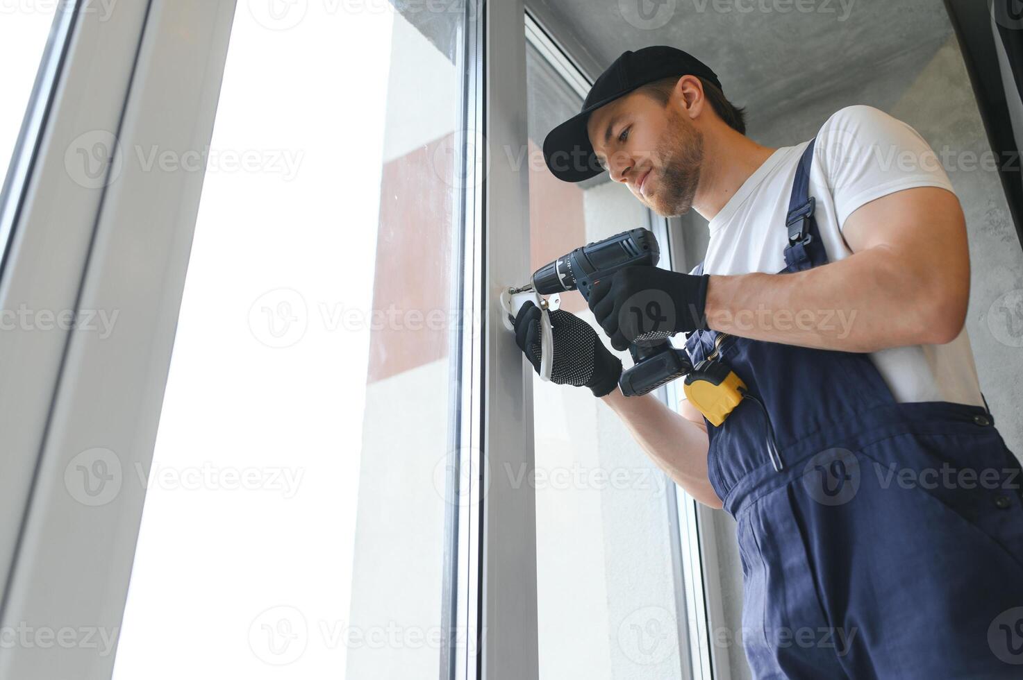 The foreman installs a window frame in the room photo