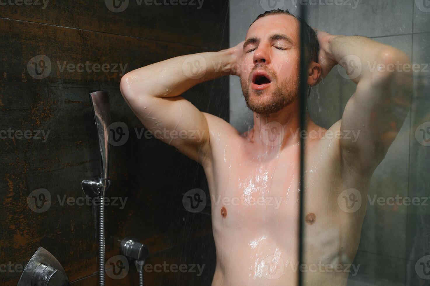 Man warming up in the shower photo