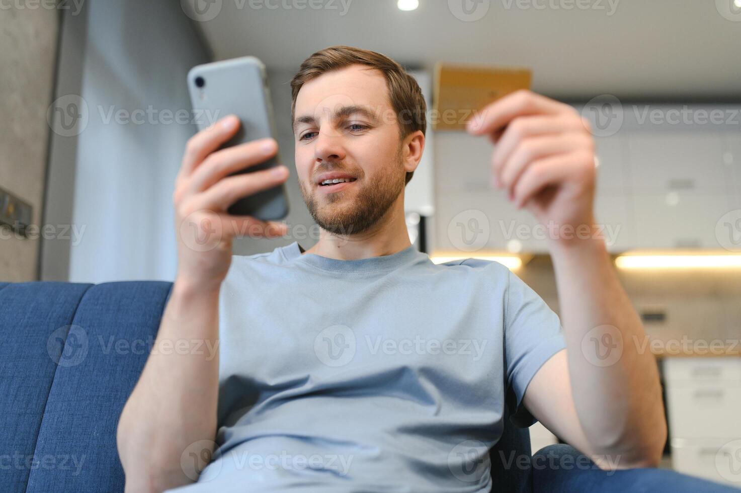 Online payment,Man holding a credit card and using smart phone for online shopping photo