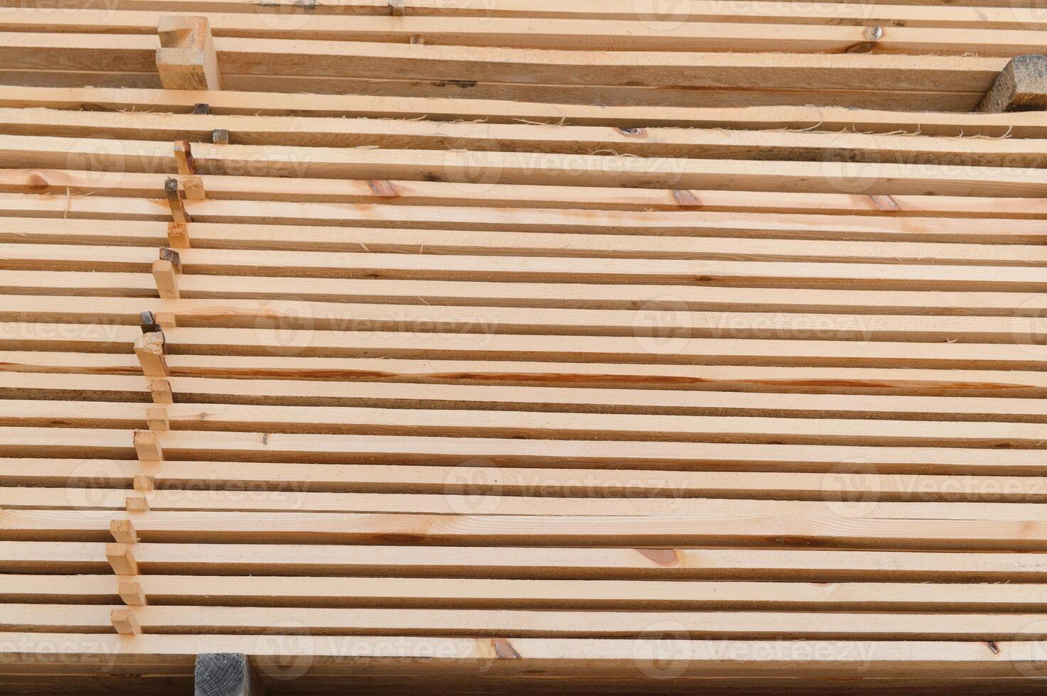 Wooden planks and beams. Air-drying timber stack. Wood air drying. Wood for house construction. Building material. Wood warehouse. photo