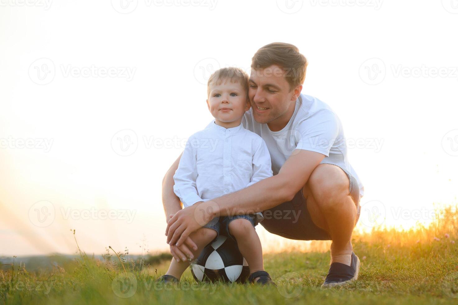 Happy father playing with son on sunset background .The concept of father's day photo