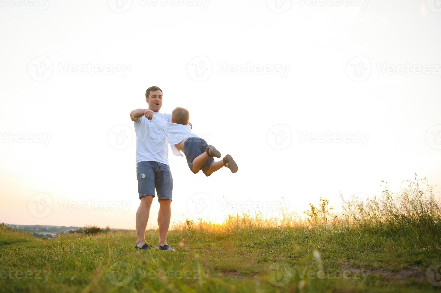 father's day. Dad and son playing together outdoors on a summer. Happy family, father, son at sunset. photo