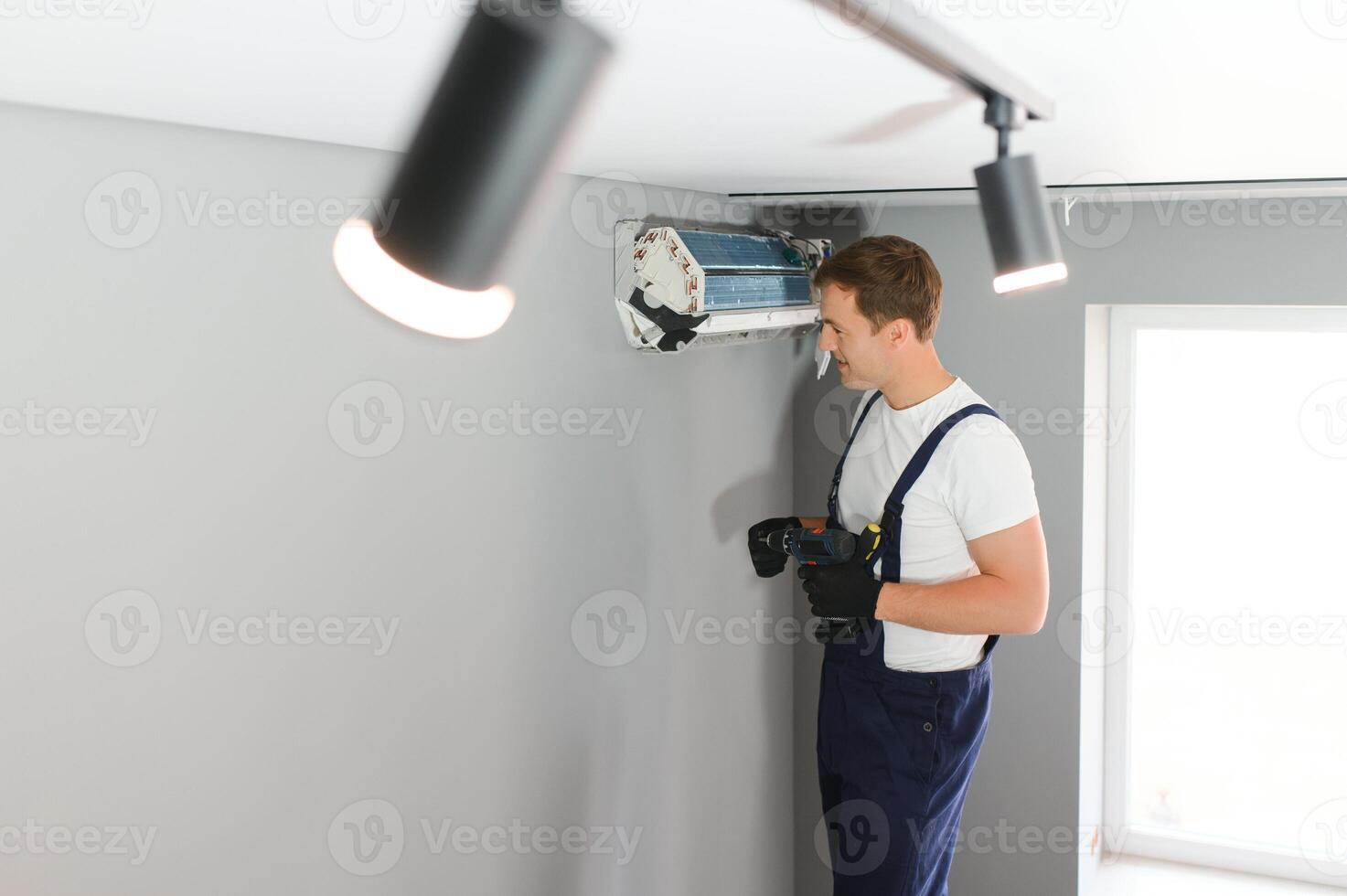 technician service checking and repairing air conditioner indoors photo