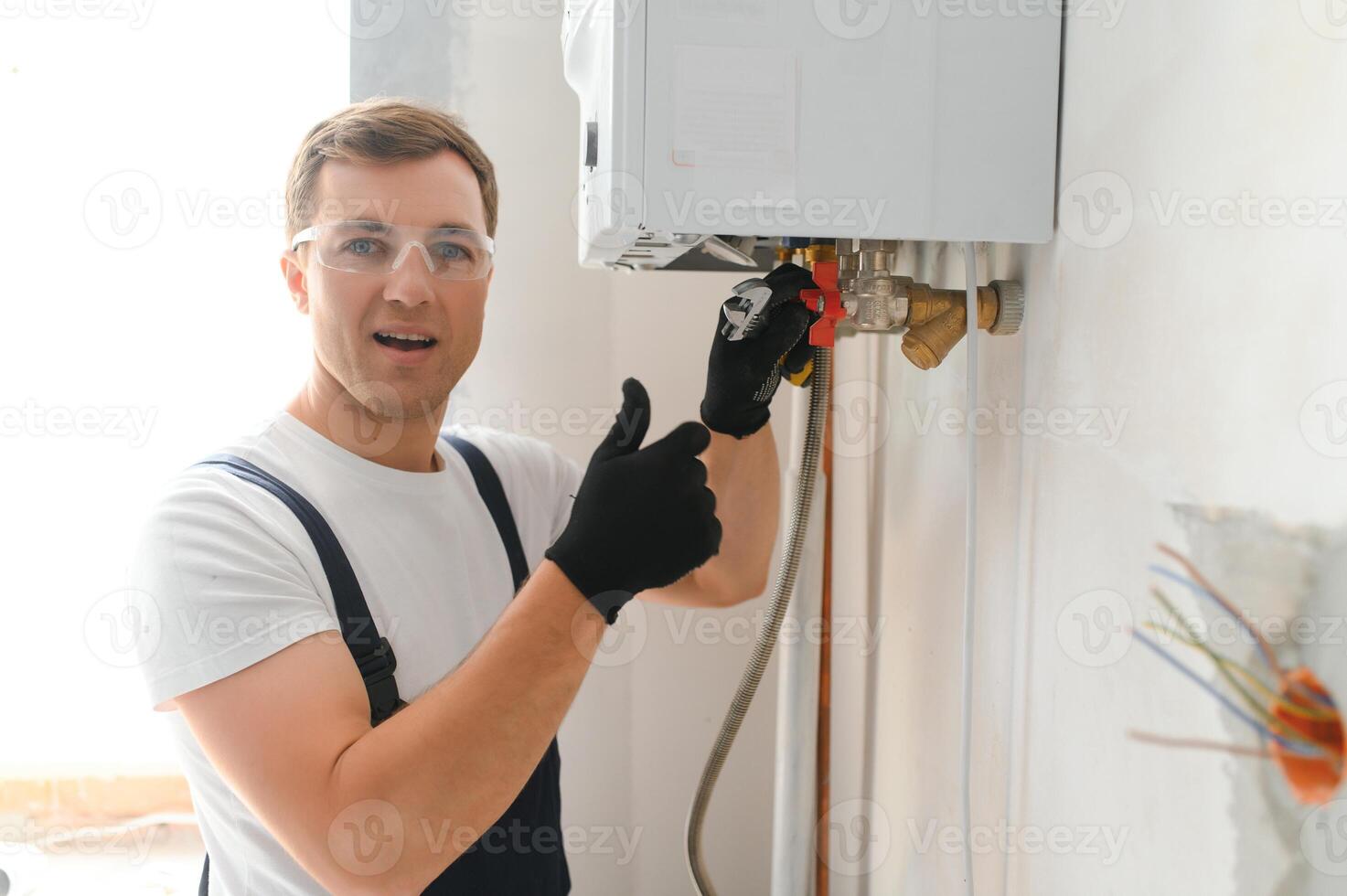 Professional plumber checking a boiler and pipes, boiler service concept photo