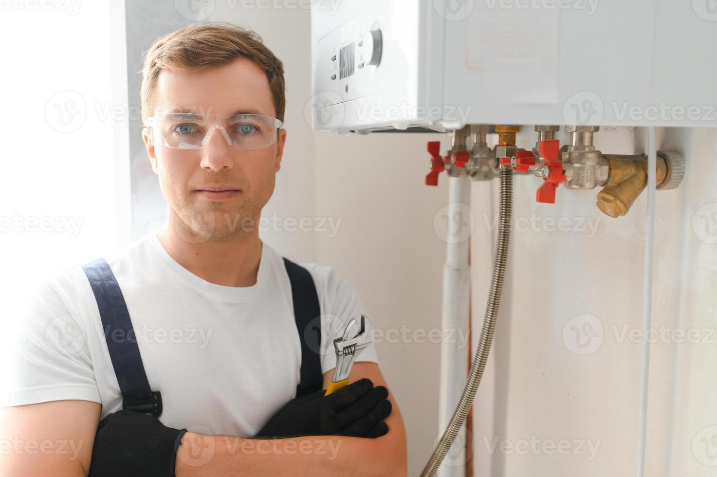 Gas engineer checking and cleaning a boiler during the inspection at home photo