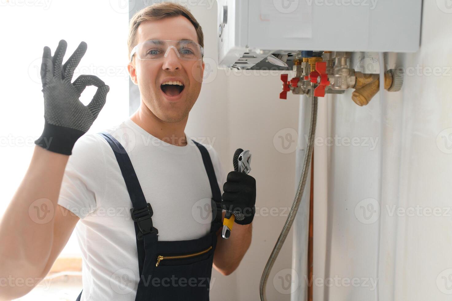 Professional plumber checking a boiler and pipes, boiler service concept photo