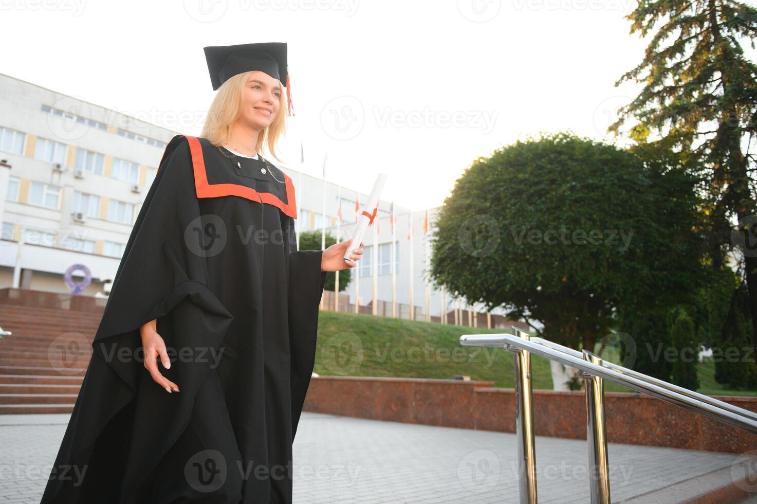 Portrait of a happy woman on her graduation day at university. Education and people. photo
