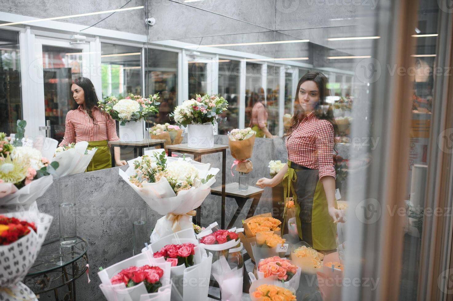 Portrait of female florist in her flower shop. photo