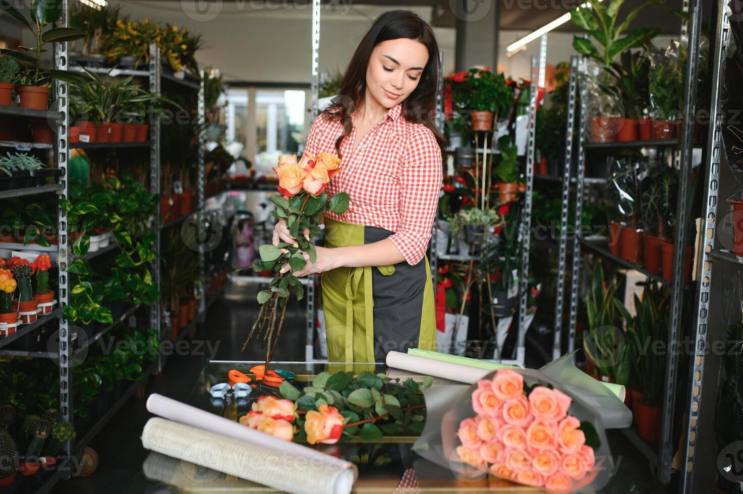 Portrait of female florist in her flower shop. photo
